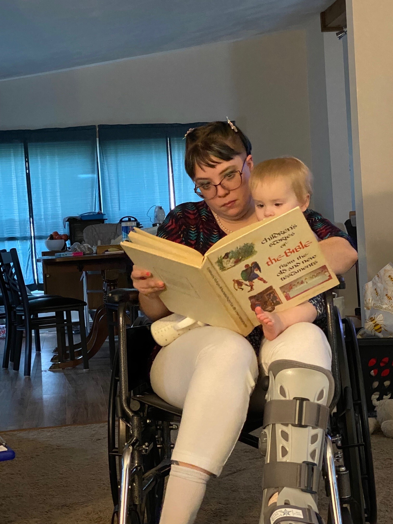 DEbra Long reading with her daughter after surgery.